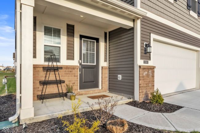 entrance to property with a garage and brick siding | Image 42