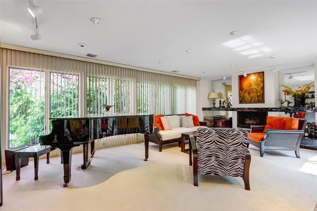 Carpeted living room featuring rail lighting | Image 11