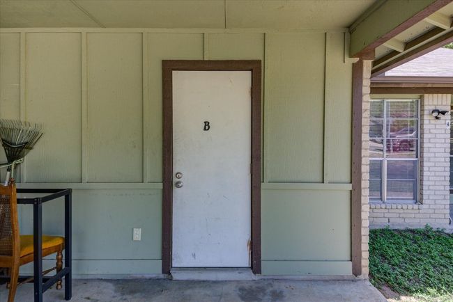 View of exterior entry with brick siding | Image 22