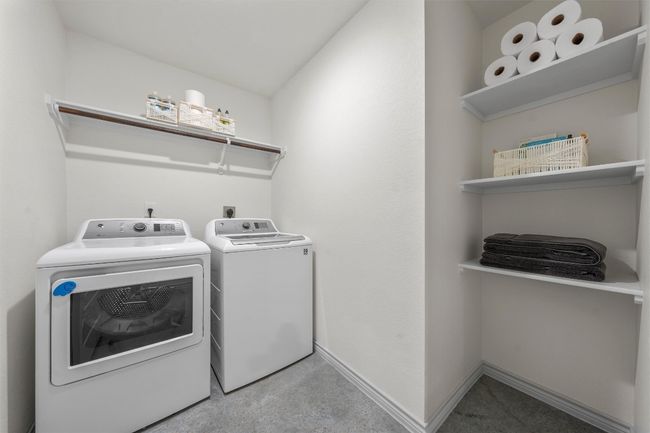 Laundry room featuring washer and dryer, baseboards, and laundry area | Image 22