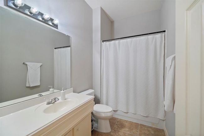 This secondary bath has lots of counter space and cabinets. | Image 21