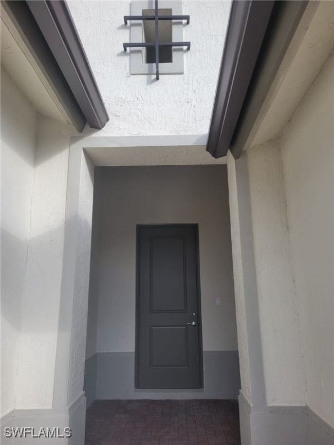 Doorway to property with stucco siding | Image 29