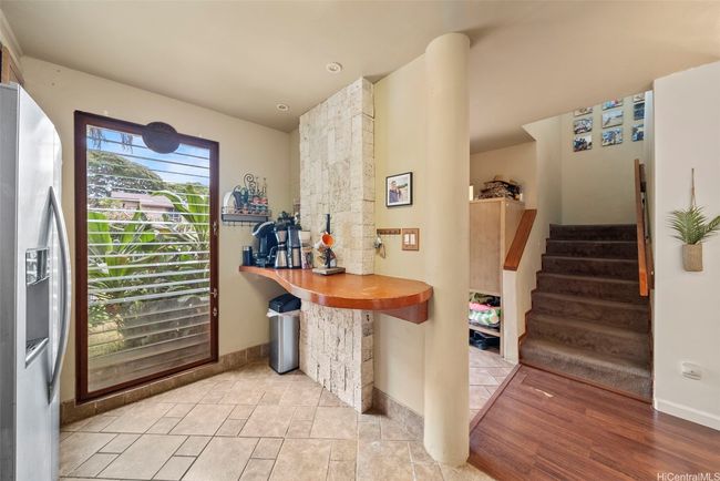 Coffee nook with a full length window, stairs leading upstairs, half bath just to the left of stairs. | Image 13