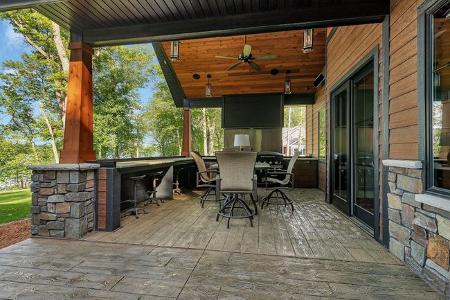 Modern patio with a fully equipped outdoor kitchen, infrared heating for year-round comfort, and built-in speakers for seamless outdoor entertainment. | Image 9