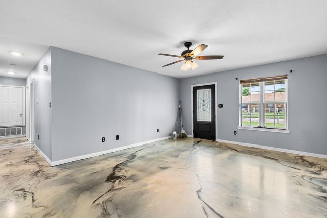 Foyer with finished concrete floors and ceiling fan | Image 17