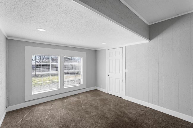 Carpeted empty room featuring a textured ceiling and recessed lighting | Image 9