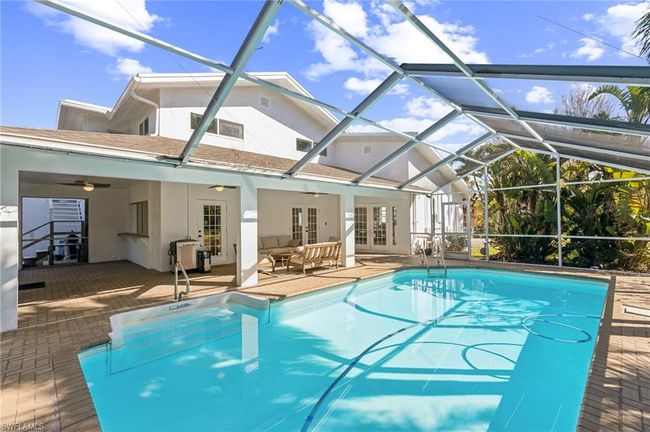 Pool, french doors, an outdoor hangout area, and a patio area | Image 9