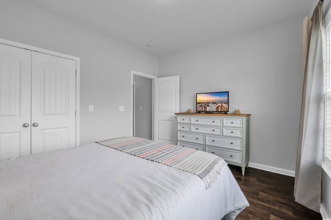 Bedroom featuring baseboards, dark wood-style floors, and a closet | Image 11