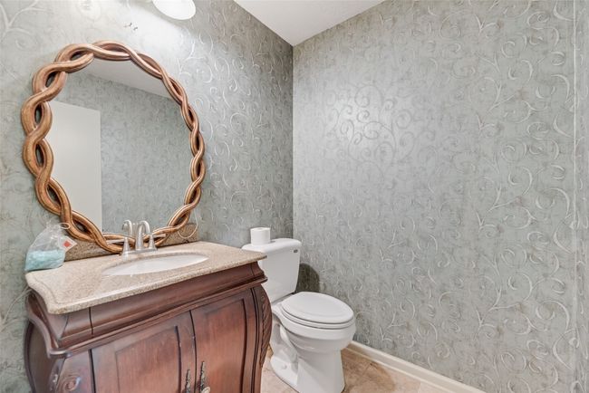 Half bathroom with tile patterned flooring, vanity, and toilet | Image 29