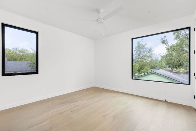 Unfurnished room featuring light wood-type flooring and ceiling fan | Image 21
