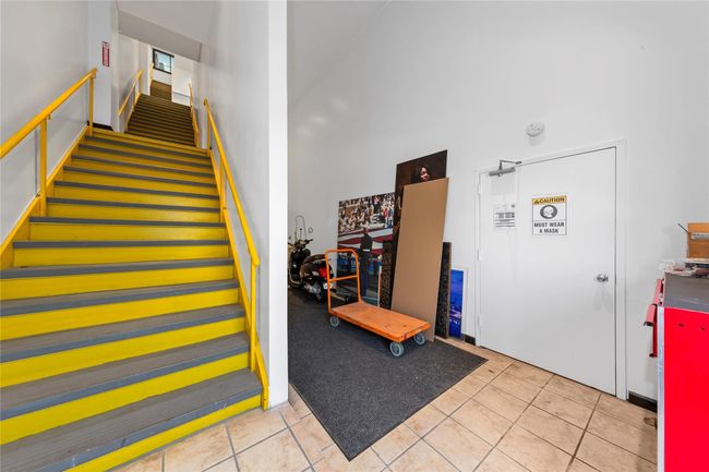 Stairs with a towering ceiling and tile patterned floors | Image 13