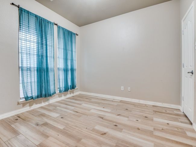Empty room with baseboards and light wood finished floors | Image 11