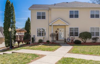 View of front of home featuring a deck and a front lawn | Image 1