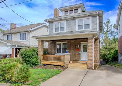 This 3 bedroom 2 bath home has parking for 2-4 vehicles with the off street parking pad to the long driveway to the former detached garage that is now used as a storage shed. There is a family room addition off the rear with a fully excavater basement below. | Image 2