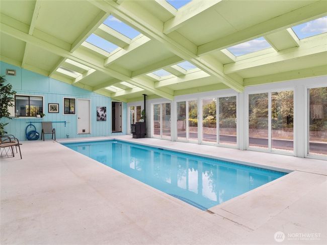 Enjoy resort-style living with an indoor heated pool enclosed in a stunning solarium. | Image 24