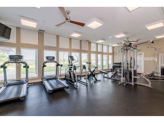 Gym with a ceiling fan and visible vents | Image 26