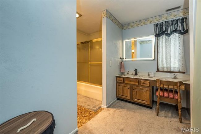 Full bathroom with double vanity and baseboards | Image 28