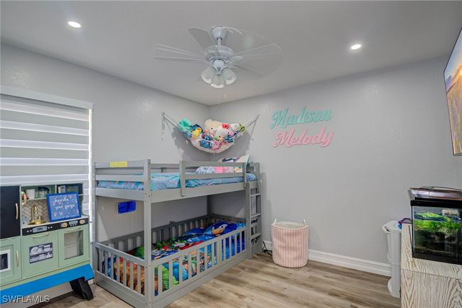 Bedroom featuring wood finished floors, baseboards, recessed lighting, and ceiling fan | Image 12