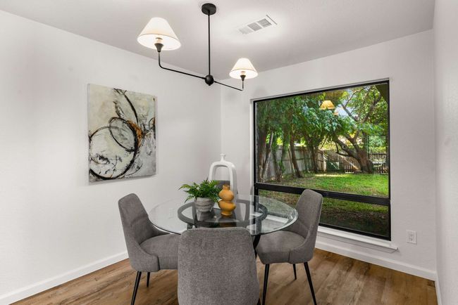 Dining space with baseboards and wood finished floors | Image 8