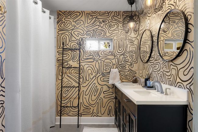 Bathroom with vanity and a shower with curtain | Image 23