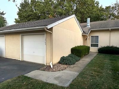 View of side of property featuring a garage and a lawn | Image 1