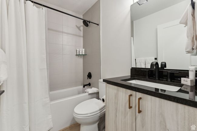 Full bathroom featuring toilet, vanity, and shower / bath combo | Image 36