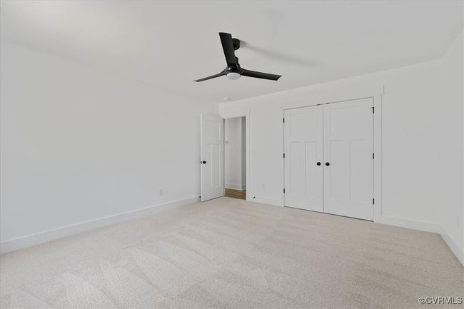 Unfurnished bedroom with baseboards, a closet, ceiling fan, and carpet | Image 23