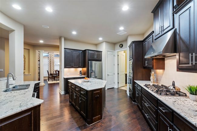 Kitchen Features Granite Countertops, Gas Cooking and Center Island | Image 11