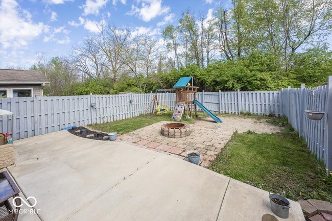 view of jungle gym with a patio area and a fenced backyard | Image 25