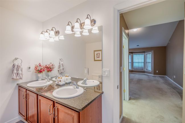 Full bathroom with double vanity and baseboards | Image 22