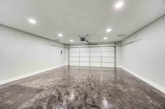 Garage with a garage door opener and recessed lighting | Image 36