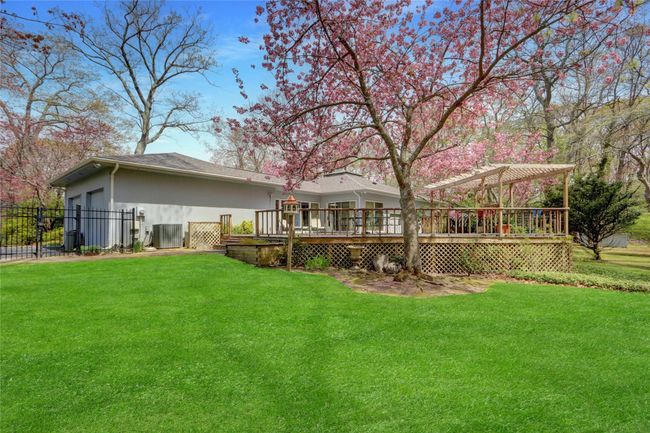 Back of house with fence, a yard, a pergola, and a wooden deck | Image 35