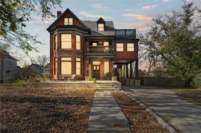 Victorian-style house with a balcony and a patio | Image 2