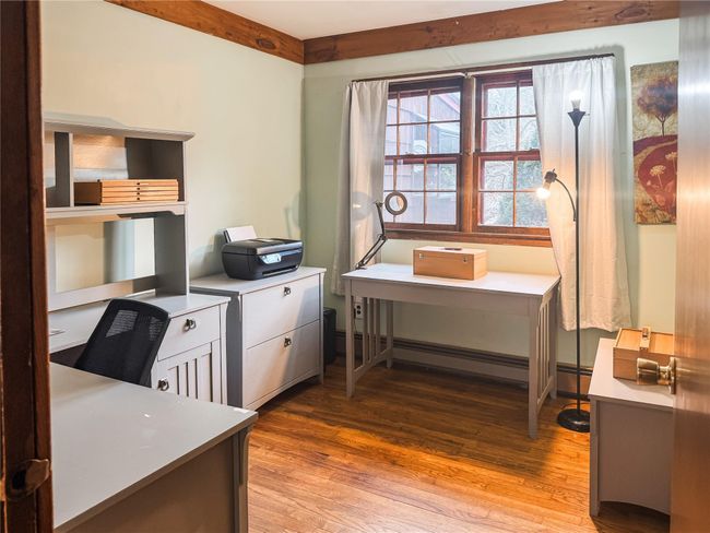 Office space with light wood-style floors and a baseboard heating unit | Image 19