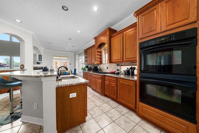 Spacious kitchen with glimpse of luxury Primary Den Area | Image 9