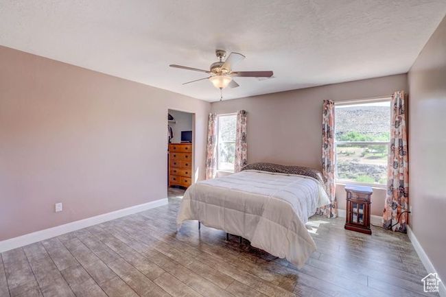Bedroom featuring baseboards, a ceiling fan, and wood finished floors | Image 17
