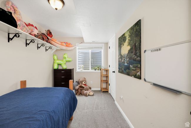 Basement Carpeted bedroom featuring baseboards | Image 21