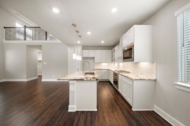 A view of the kitchen from the dining area. | Image 5