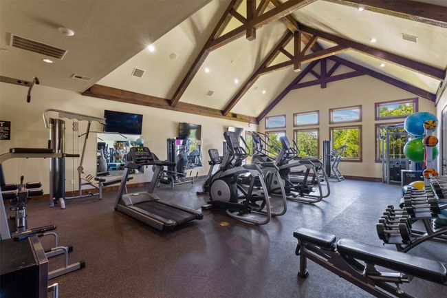 Exercise room with high vaulted ceiling, beam ceiling, and recessed lighting | Image 14