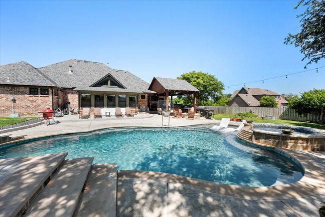 View of pool with a patio area, a gazebo, a fenced backyard, and a pool with connected hot tub | Image 30