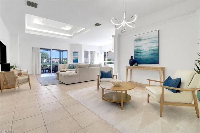 Living area featuring light tile patterned floors, a notable chandelier, visible vents, and a healthy amount of sunlight | Image 6