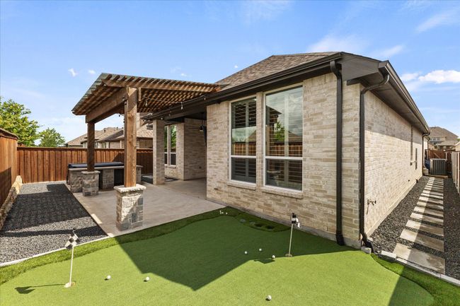 Back of house with a patio area, a putting green, a fenced backyard, and a pergola | Image 32