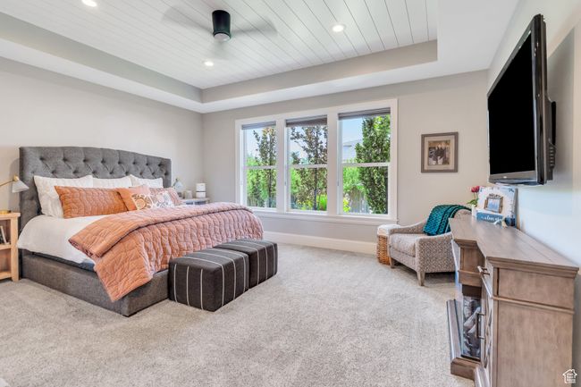 Carpeted bedroom with a raised ceiling, recessed lighting, and wood ceiling | Image 28