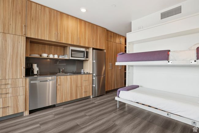 Kitchen featuring a sink, modern cabinets, stainless steel appliances, open shelves, and visible vents | Image 11