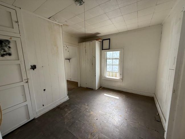 Unfurnished bedroom with wooden walls | Image 12