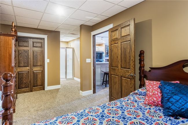Carpeted bedroom featuring baseboards and a drop ceiling | Image 44