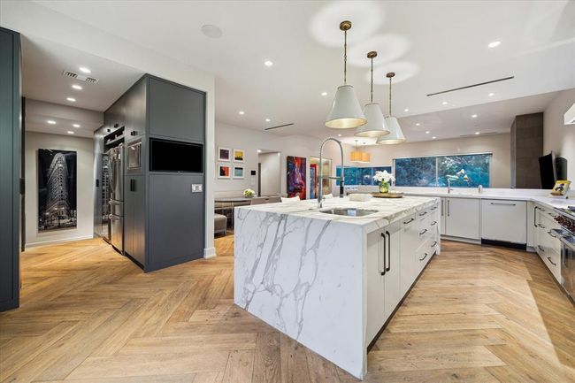 The 10' x 8' Butler’s Pantry—labeled as “The Hall” on the floor plan—is packed with hidden luxuries. One side is fully equipped with a built-in TV, microwave, second full-size French door refrigerator, a wine column, and discreet access to the AV/IT rack closet. It’s a hardworking space that keeps the kitchen clutter-free and entertaining effortless. | Image 12