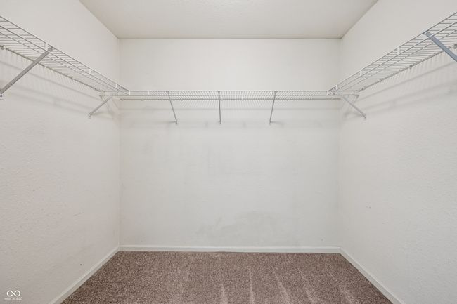 walk in closet featuring carpet | Image 26