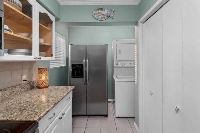 Kitchen with stackable washer and dryer | Image 8