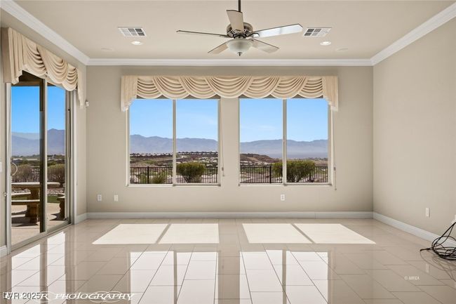 Spare room featuring crown molding, a mountain view, and a healthy amount of sunlight | Image 31